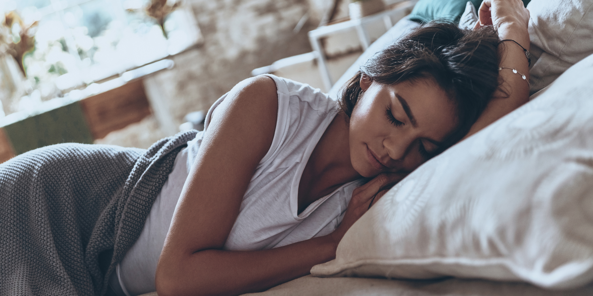 Frau im Bett - Wie man Schlafstörungen während der Menstruation vorbeugen kann.